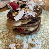 Pancakes with peanut butter, raspberries, and blackberries (plus coconut and granola)  at Peanut's Café in Sainte-maxime