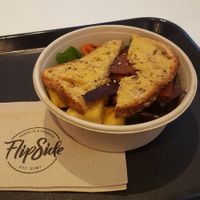 unrise breakfast bowl. Crispy facon, tofu scramble, grilled mushrooms and tomatoes served with 'buttered' toast at Flipside in London