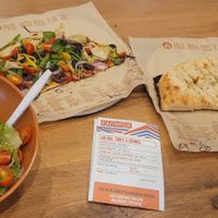 Half pizza with a salad and breadsticks with vegan cheese at Blaze Pizza in Melbourne