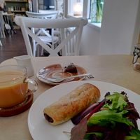 vegan haggis roll, breakfast tea with oat milk, in a corner booth  at Cafe Wynd in Dunfermline