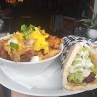 Seitan pita with a really good tzatziki and a side of poutine. at Nooch in Windsor