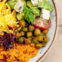 Mixed platter of hot food and avocado salad  at Erpingham House at Cloud Twelve in West London