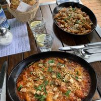 Baked gnocchi in front, baked penne in back. Garlic and herb bread in basket. at Rococo in Hawthorn