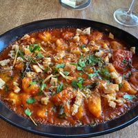 Vegan baken potato gnocchi oven baked in tomato & basil sugo topped with candied pumpkin, pangrattato, vegan mozzarella at Rococo in Hawthorn