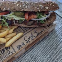 Seitan Sub: Seitan served in wholemeal baguette, mixed leaves, beef tomatoes, onions, gherkins, sriracha mayo and side of chips. at Balance Bowl in Gzira