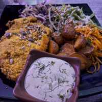 Schnitzel with potatoes, salads and dill sauce at Balance Bowl in Gzira