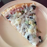 A slice of veggie pizza with vegan cheese and artichoke hearts at LaRocca's Pizza in Topeka