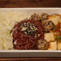 Veggie balls and tofu marinated in sweet and sour tomato sauce, served with brown rice and sauteed shredded cabbage. The veggie balls gave me one of the best vegan experience! at Mang's Mania in Ho Chi Minh City