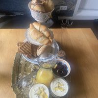 Breakfast for 2: cinnamon rolls, choco croissants, toasties, cream cheese sandwiches, orange juice, fruit and coconut yoghurt with hemp seed and granola. Homemade and delicious.  at Villa La Vida in Egmond Aan Zee