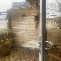 Balcony, part of Flamingo room. It has a roof and a lamp in it (switch is in the room) at Villa La Vida in Egmond Aan Zee