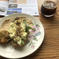 Tofu scramble with potato cake side and iced black coffee  at Moment in Christchurch
