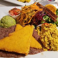 Weekend brunch with polenta, guacamole, black beans, scrambled tofu, tempeh bacon and salad at Aux Vivres - St Laurent in Montreal
