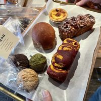 Vegan scones, vegan cinnamon roll and pumpkin roll, coconut cream sandwich - the egg tart is NOT vegan  at Doco - City Farm House Cafe in Busan