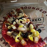 GF crust, sweet red sauce, grilled chicken, banana peppers, black olives, cooked mushrooms, roasted tomatoes at Rapid Fired Pizza in Sandusky