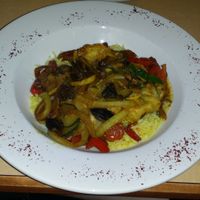 Vegetarian Delight - Fresh mushrooms, green & red peppers, yellow squash & zucchini sautéed in olive oil & our special blend of seasonings topped with feta cheese, served on top of rice (remove feta to make vegan) at Petra Cafe in Hattiesburg