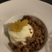 Dolce, mousse di cioccolato bianco con crumble alla cannella e “caviale” di frutto della passione, spettacolare  at La Cullera in Alghero