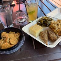 Soul food plate with 2 drumsticks, collard greens, Mac n cheese, and cornbread. Fried pickles for appetizer and red velvet cupcake for dessert. Trust me. It’s all gone now 😋 at VelTree in Charlotte