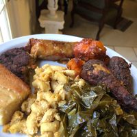 Vegan Drumsticks, Mac and Cheese, Sweet Potato Yams, Collard Greens, Cornbread, Soul Roll, and Half of my dad’s vegan crab cake on a plate! at VelTree in Charlotte