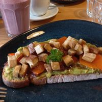 Made up toast with avo, smoked tofu, caramelized onion and pumpkin, try it! at Fauna & Flora in Lisbon