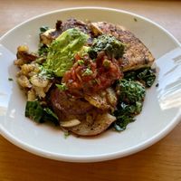 Phoenix Potatoes (the vegan version) - breakfast potatoes with grilled tofu, onions, kale, pico, chimichurri, and avocado.   at Cafe Phoenix in Arcata