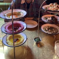 Mezze Trio with cauliflower, falafel and baba ganoush on the right, hummus trio on the left  at NENI in Hamburg