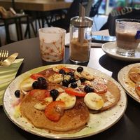 Pancakes with strawberries, banana and blueberries at Happy Food and Health  in Rotterdam