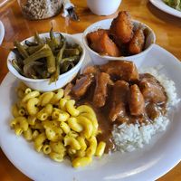 Smother chicken w/gravy on rice with Mac n cheese. Sweet potatoes and green beans at Binge Kitchen in San Antonio