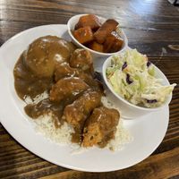 Smothered chick’n and gravy with 3 sides—mashed potatoes, coleslaw, and yams  at Binge Kitchen in San Antonio