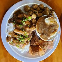 Smothered chicken with fried okra, mashed potatoes, and wedges. at Binge Kitchen in San Antonio