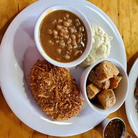 Coconut fried chicken with baked beans, potato salad, and potato wedges. at Binge Kitchen in San Antonio