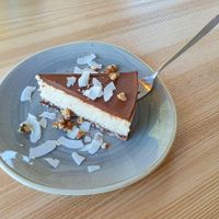coconut-based vegan "cheesecake" with chocolate on top at Strh Cafe & Gallery in Zakopane