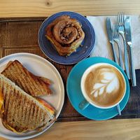 Cheese & tomato toasty, cinnamon bun & coffee with oat milk. at Macaroca in Porto