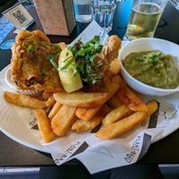 Fish & Chips with mushy peas. Tartar sauce hiding behind fish. at Unity Diner in East London