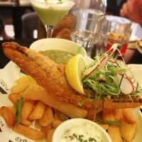 Tofish and chips. Behind, the cocktail Vegan Propaganda at Unity Diner in East London