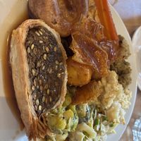 Mushroom Wellington, Yorkshire pudding, carrot, parsnip, crackling, stuffing Brussels, cabbage + peas, leek gratin, cauliflower cheese and plenty of gravy!   at Unity Diner in East London