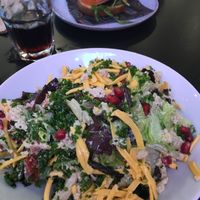 Caesar salad & gf surge burger in the back  at Unity Diner in East London