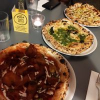A vegan pizza, vegan garlic bread and a veggie pizza at Bertha's Pizza in Bristol