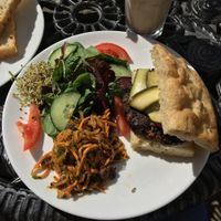 Black bean and portobello mushroom burger with coleslaw and salad  at Greens Vegetarian Cafe in Hebden Bridge