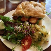 Smoked tofu sandwich - lunch menu. Loved the side of potato. at Greens Vegetarian Cafe in Hebden Bridge
