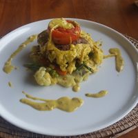 Vegan steak (grilled red kidney bean patties on onion curry sauce with sautéed vegetables and sweet potato mash) at Pissari Bali Cafe in Ubud