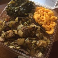 Jerk ";chicken"; over rice with Mac n cheese and collards  at Senbeb Cafe in Washington