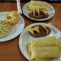 Sweet corn tamales, jalapeno & bean papusa (wow!!), sides of beans and casamiento (bean and rice mix). The papusa includes pickled slaw. at Fernanda's Salvadorian in Cathedral City