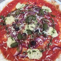 Vegan pizza with tofu cream, olives, capers, onions, vegan Parmesan  at Hotel Europa in Molveno