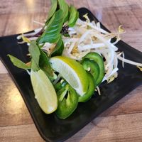 Bean sprouts, jalapeños, Thai basil, and limes for the pho at Pho Van in Pittsburgh