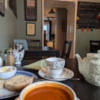 Cherry tea with red pepper and tomato soup, and bread role with vegan spread. at The Herb Garden in Buxton