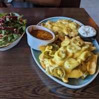 Mushroom cheese schnitzel with cheesey fries and a salad at Apple & Eve in Hamburg