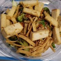 White rice, spinach, cucumber, carrots, broccoli, tofu, onion crisps, wontons and eel sauce at Ohana Poke & Sushi Burrito in New Braunfels