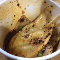 Not the best photo: the dumplings come in  a delicious Szechuan sauce. at Gu's Dumplings in Atlanta