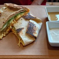 Tortilla with vegan ham and cheese, sour cream and a dressing at Palmovka in Prague
