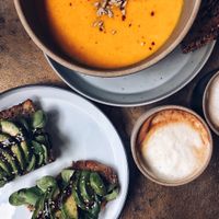Avocado bread and carrot ginger soup with oat cappuccino at Balance Deli in Frankfurt